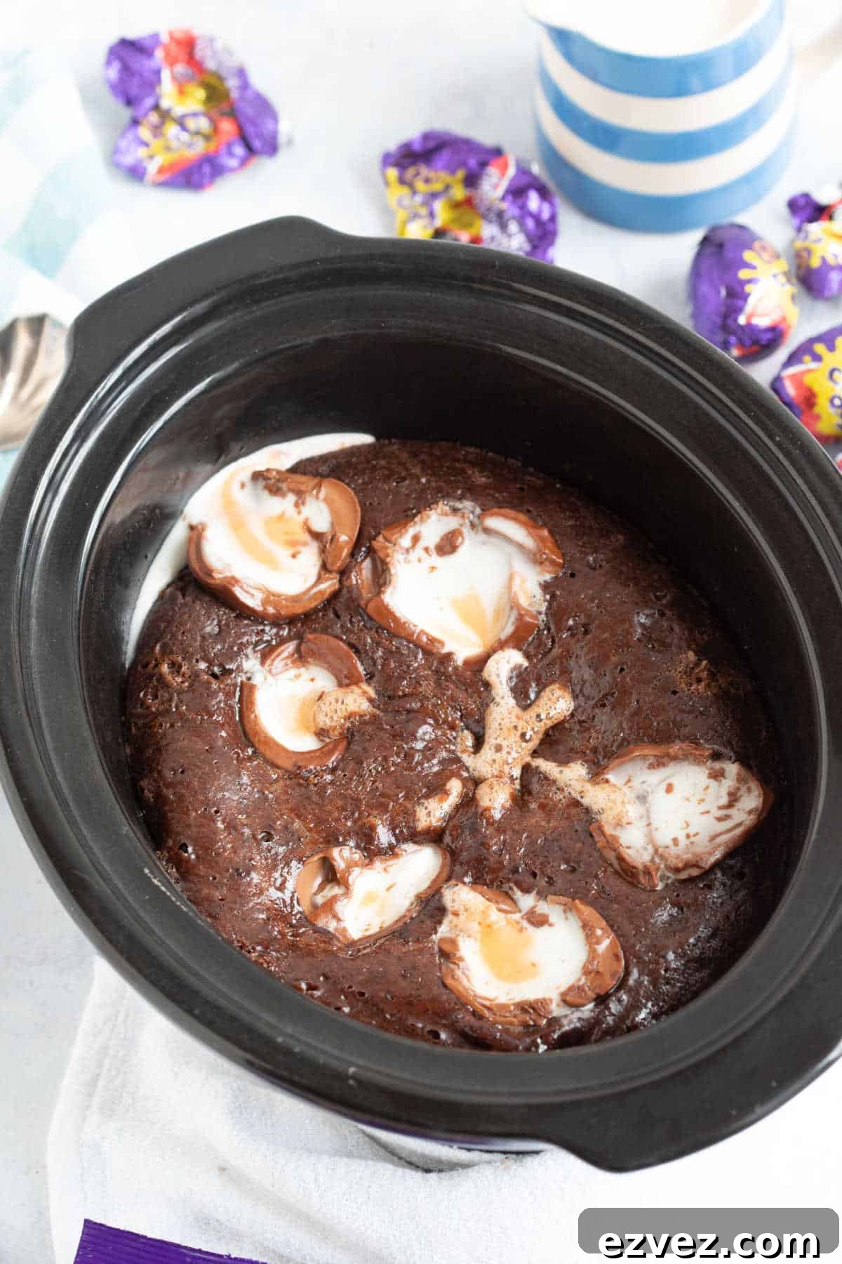 Slow cooker self-saucing chocolate pudding with halved Cadbury creme eggs on top.