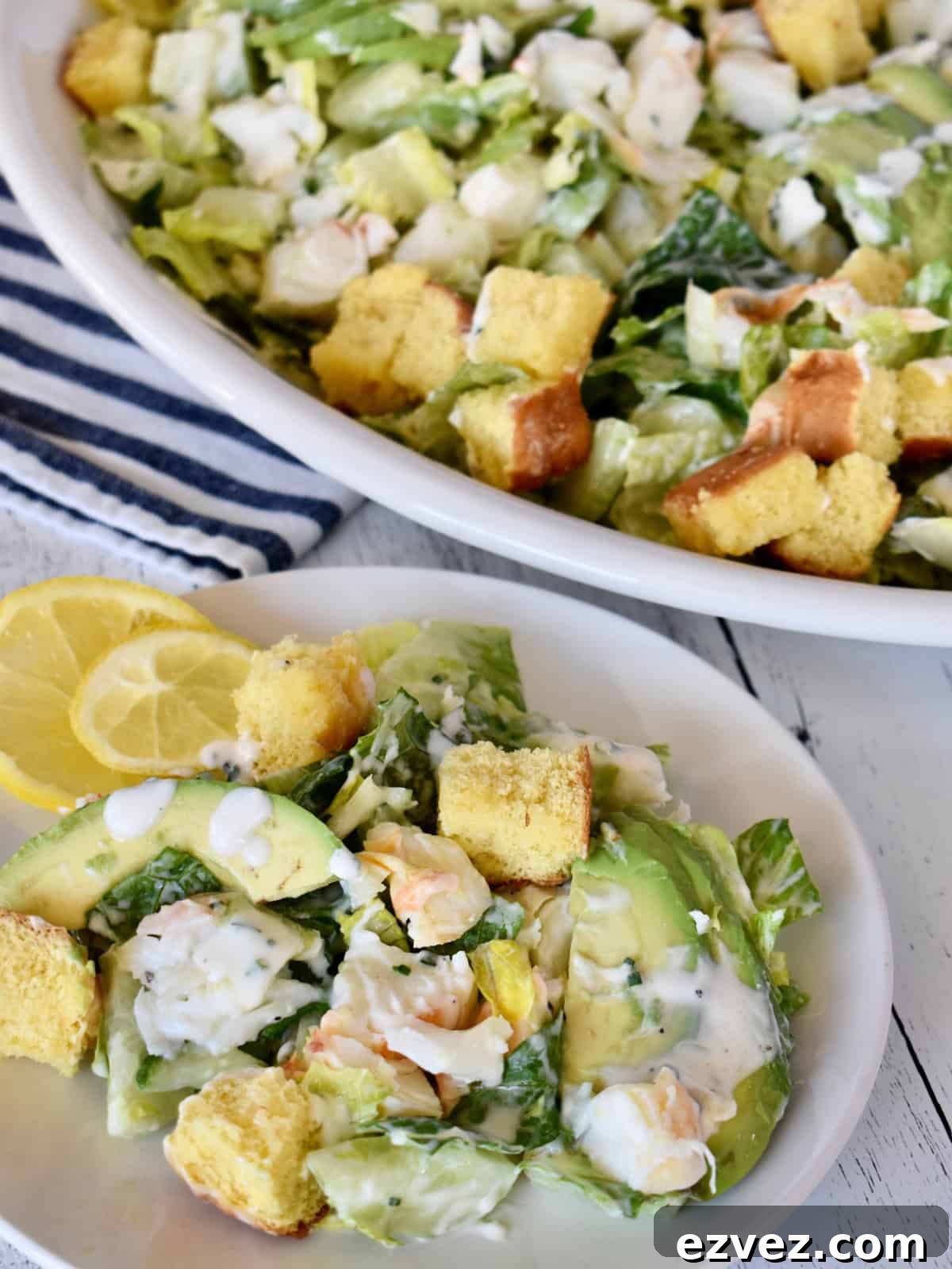 Lobster Roll Salad on a serving plate with brioche croutons. 