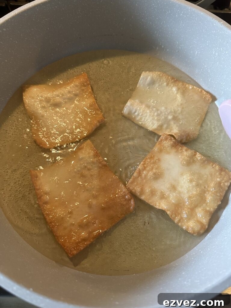 Won ton pieces crisping up in oil in the pan