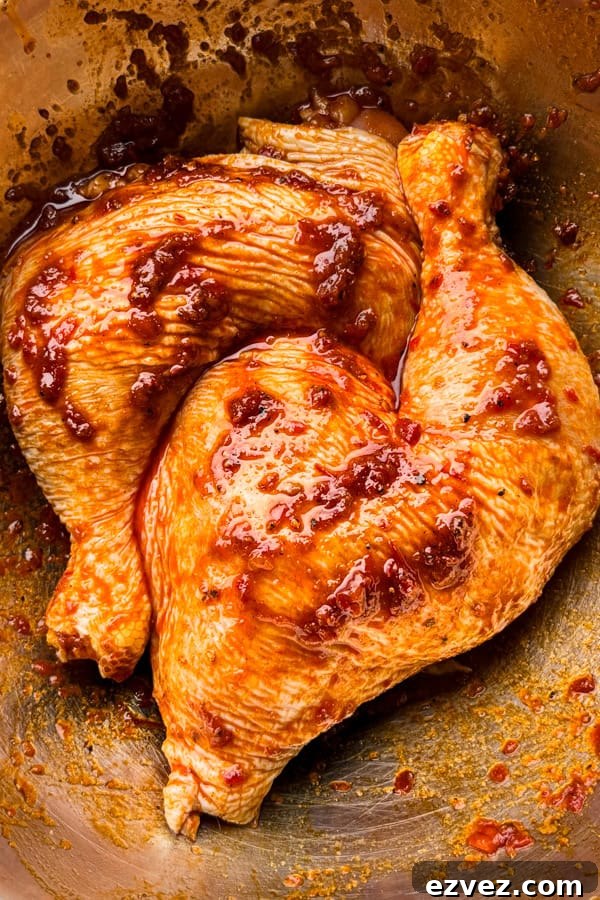 chicken marinating in a blend of harissa paste and spices