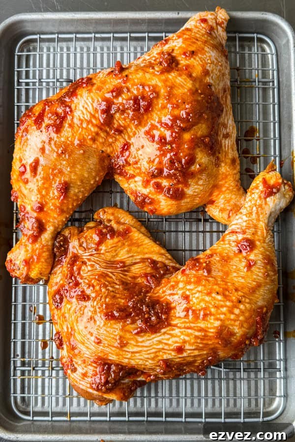 chicken marinating in a blend of harissa paste and spices