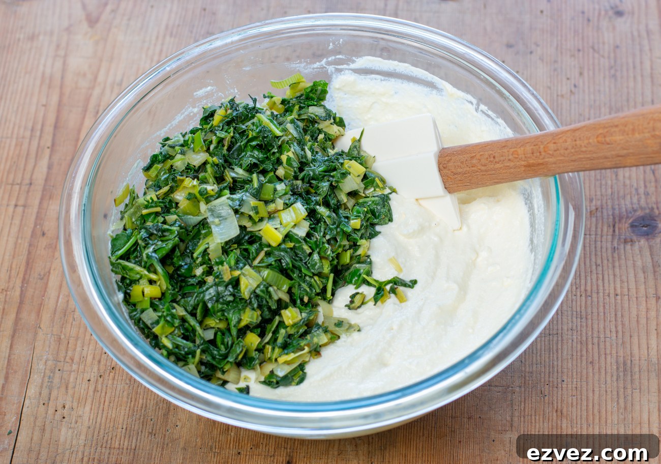 Mix egg and ricotta, then fold in the cooled vegetable mixture