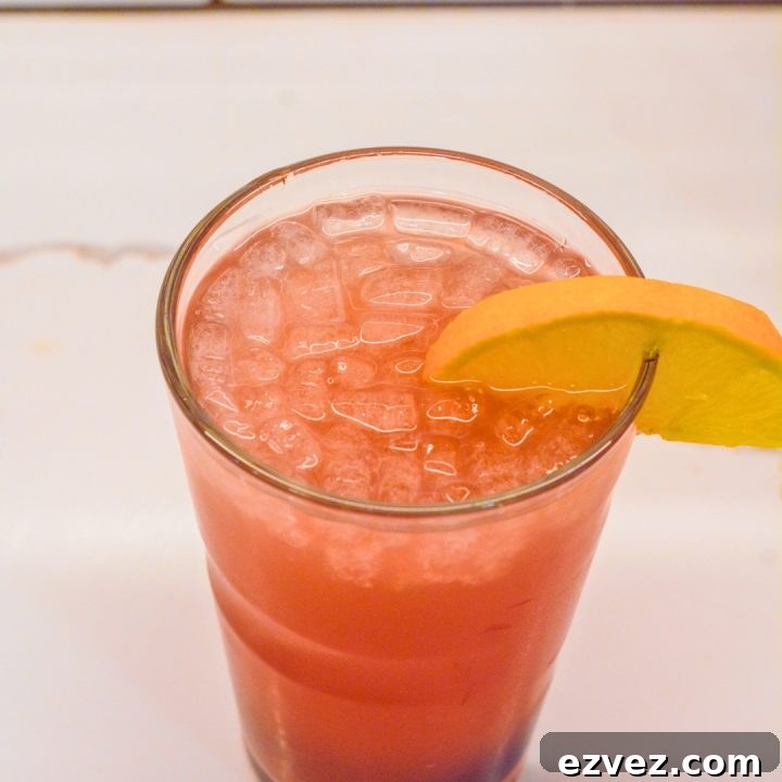 Garnish the cocktail with the decadent maraschino cherries called Luxardo Maraschino Cherries and an orange slice.