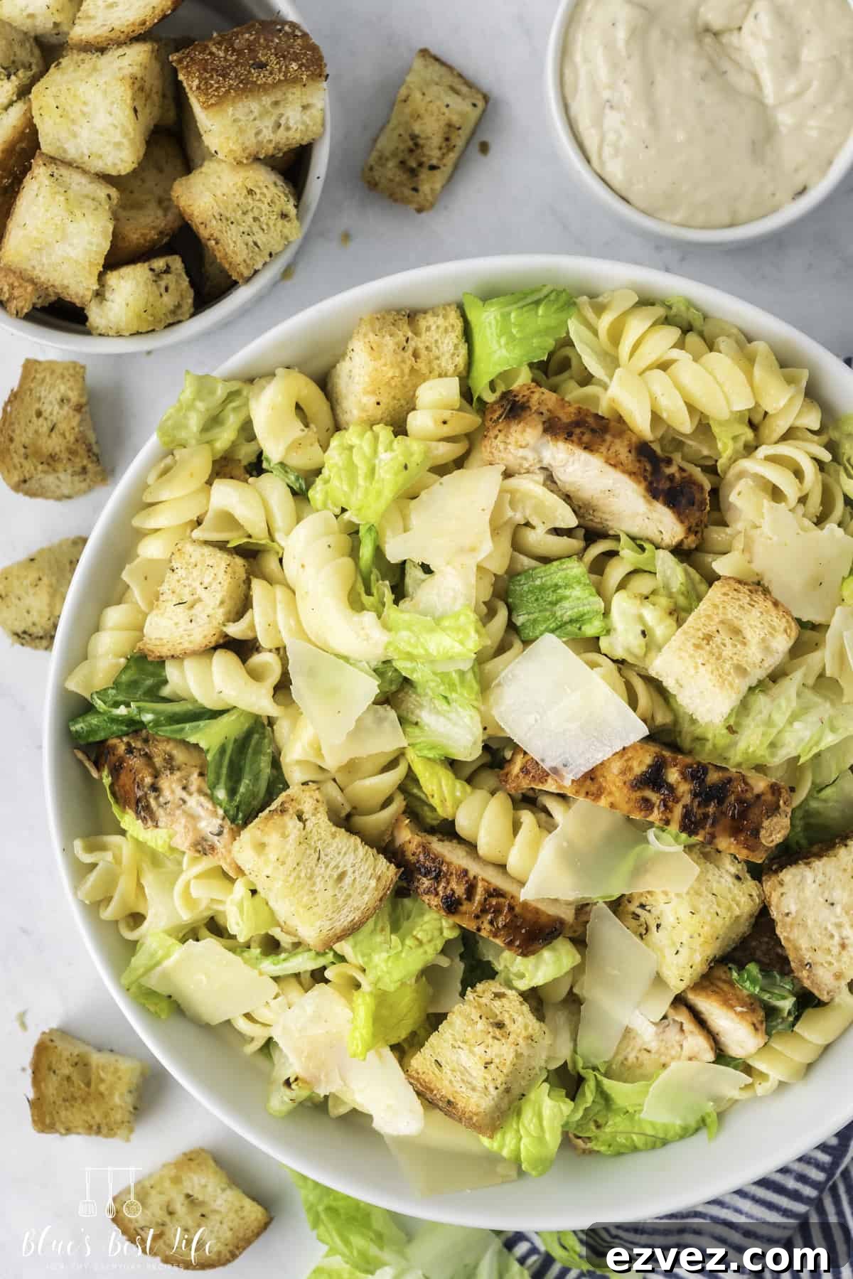 Top shot of a bowl with chicken Caesar pasta salad. 