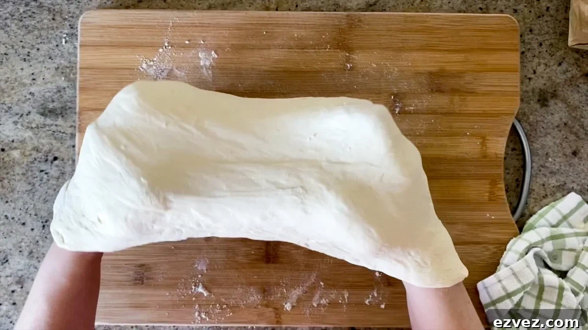 stretching pizza dough with knuckles