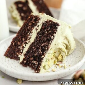 A slice of pistachio chocolate cake on a small plate.