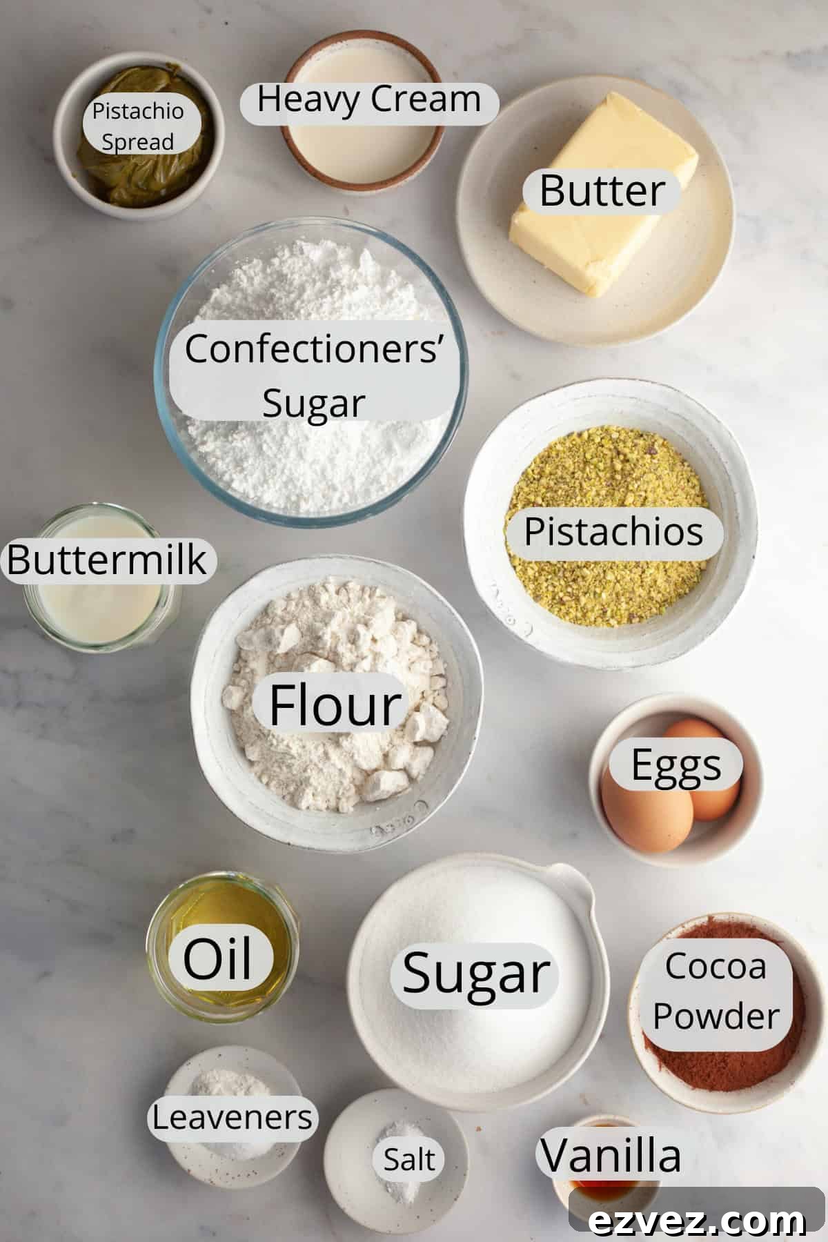 All the ingredients needed to make pistachio chocolate cake, weighed out into small bowls.