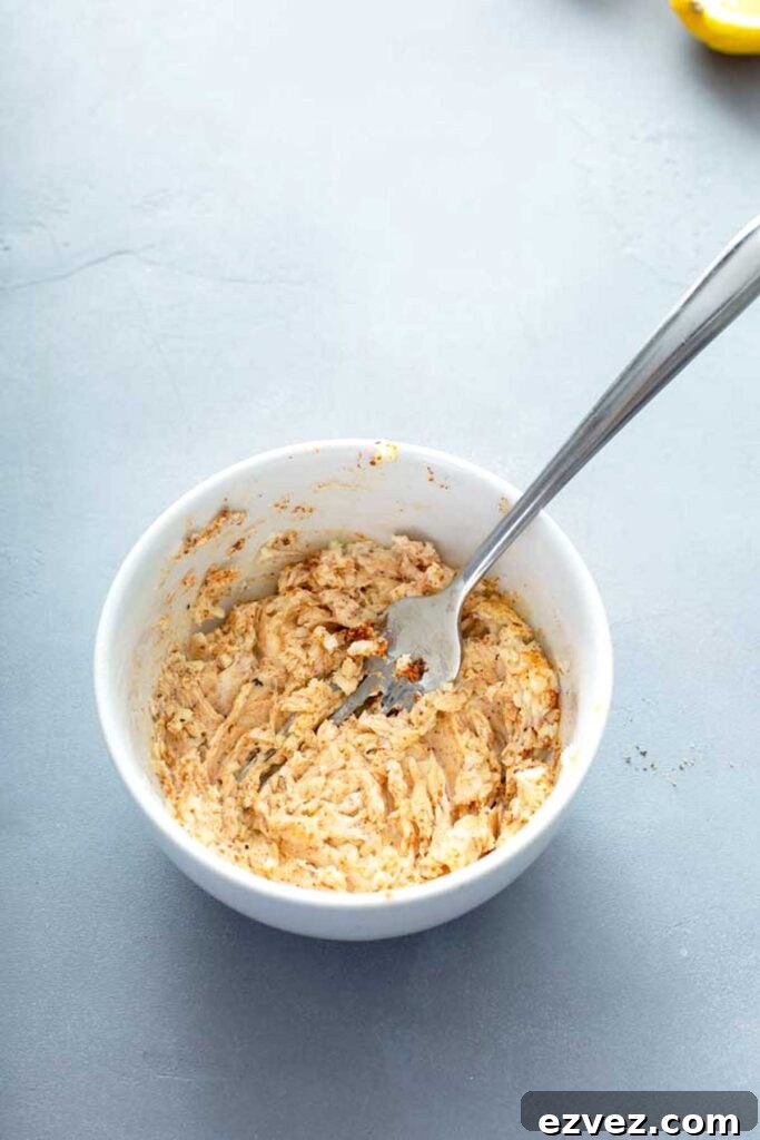 Mixing Cajun butter in a white bowl