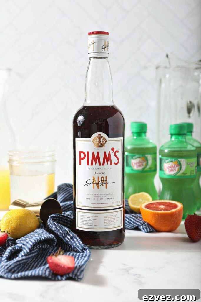 Pimm’s Punch Recipe: Classic Summer Cocktail Guide 3 A bottle of Pimm's No. 1 next to other punch ingredients on marble