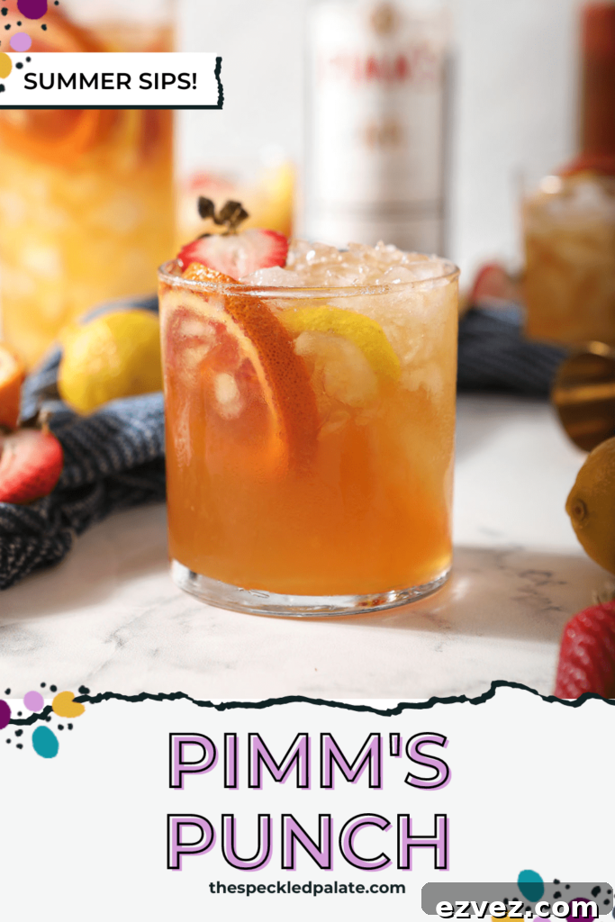 Pimm’s Punch Recipe: Classic Summer Cocktail Guide 7 A glass of a Pimms drink garnished with blood orange, lemon and strawberry with the text Pimm's Punch
