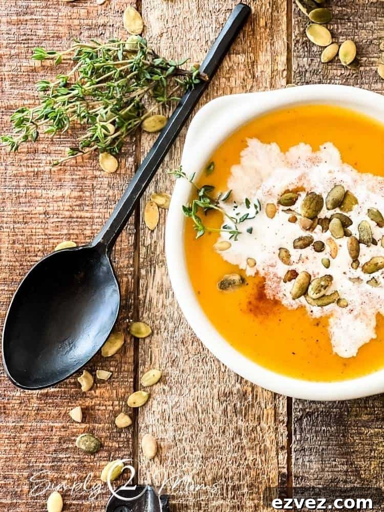 Bowl of savory butternut squash soup on a wood board with a black iron spoon