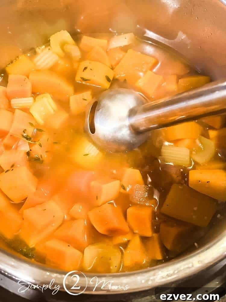 Cooked autumn squash in an instant pot with broth and immersion blender