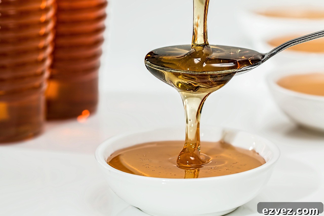 Agave Syrup Substitutes Every Baker Should Use 4 pouring syrup into a spoon over a bowl