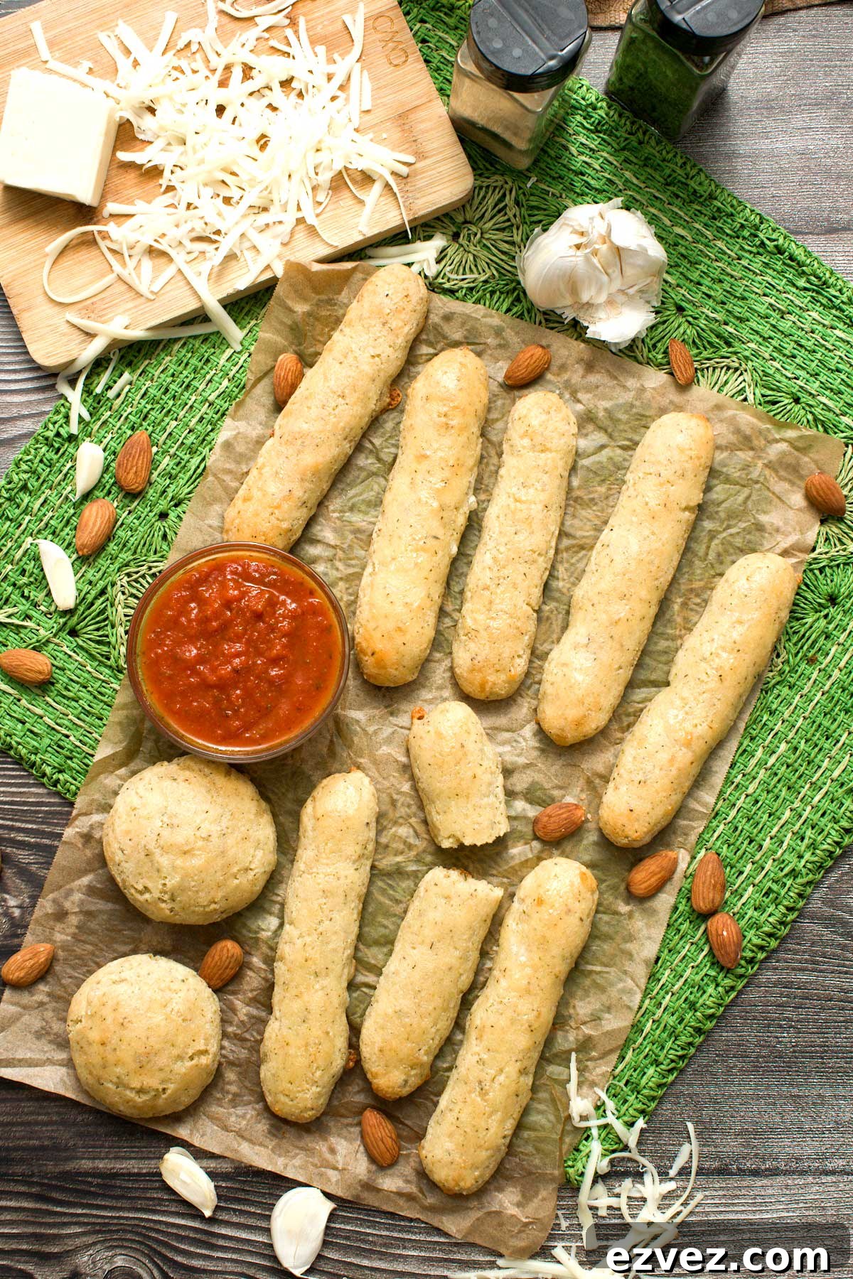 Gluten-free Olive Garden copycat breadsticks spread out on a sheet of parchment paper.