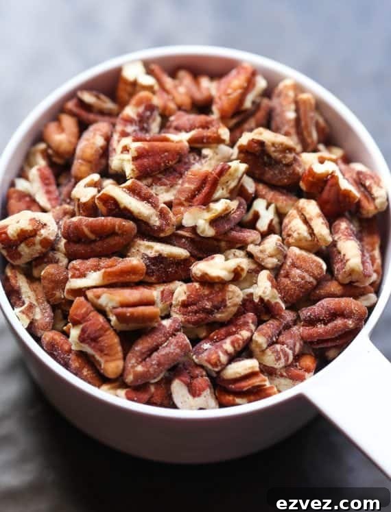 Chopped pecans in a measuring cup.