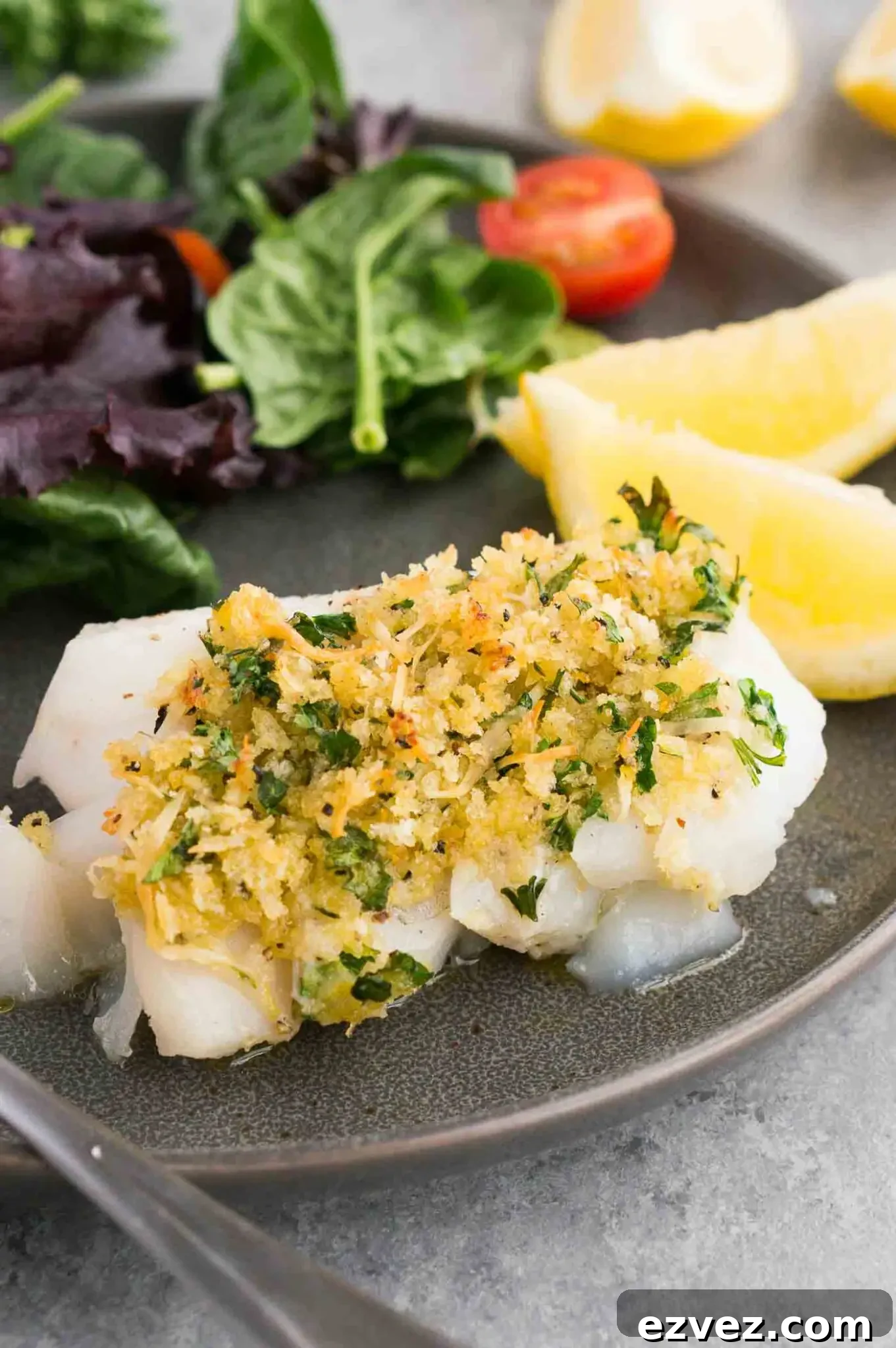 baked cod with salad on a plate