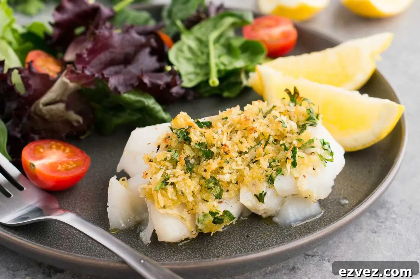 Crispy Oven-Baked Cod with Lemon and Garlic 3 close up image of cod with topping on a plate