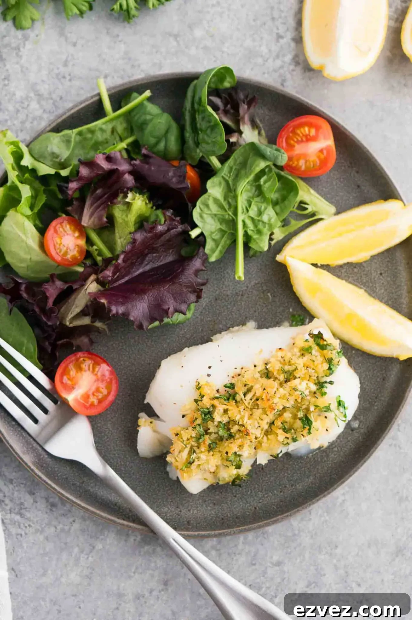 Crispy Oven-Baked Cod with Lemon and Garlic 6 white fish with salad on a plate