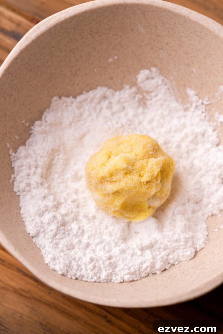 Cookie dough ball in powdered sugar.