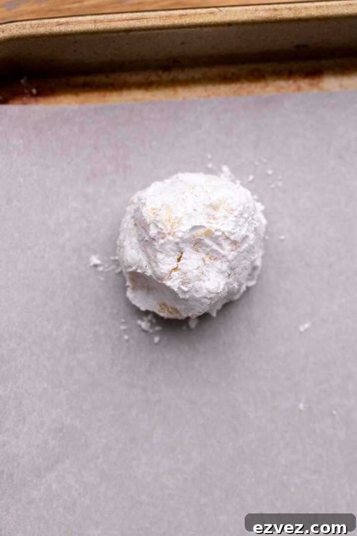Cookie dough ball covered in powdered sugar.