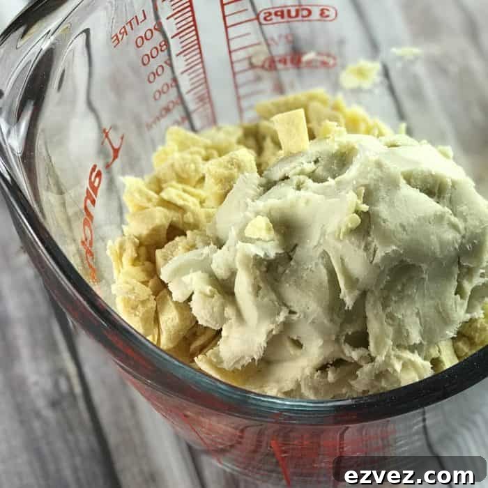 cocoa butter and shea butter in glass measuring cup ready to be melted for use in Lush Buffy Bar with essential oils