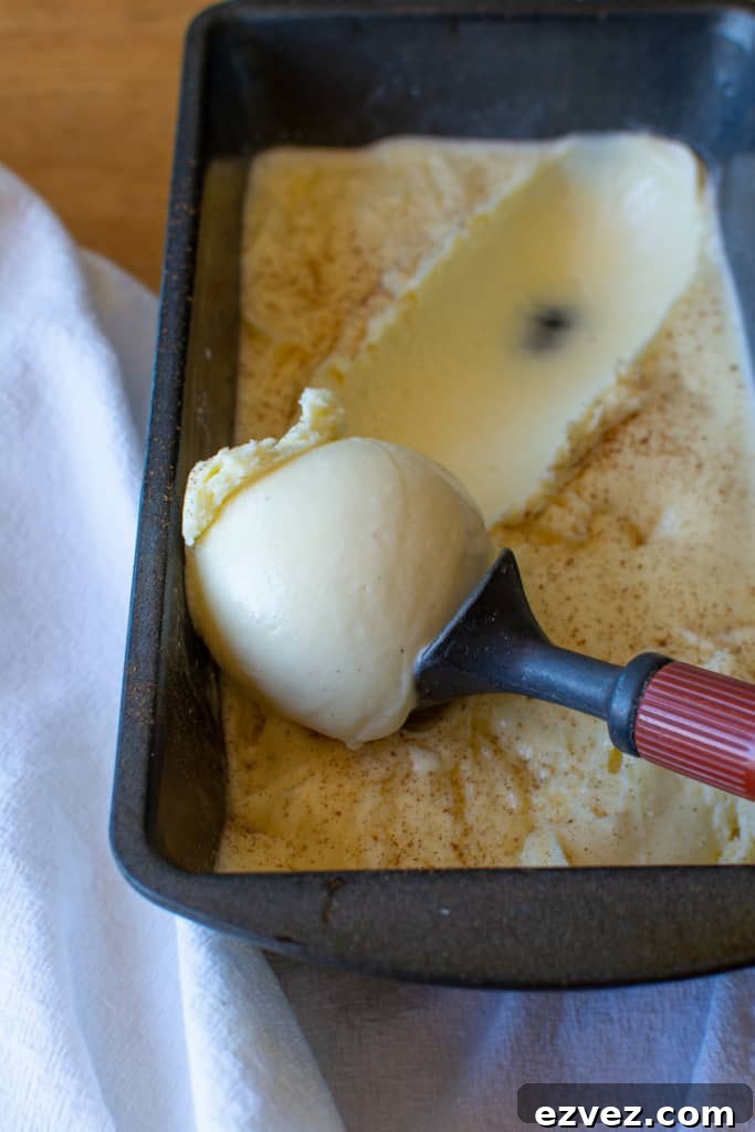 Cinnamon ice cream being scooped with an ice cream scoop. 