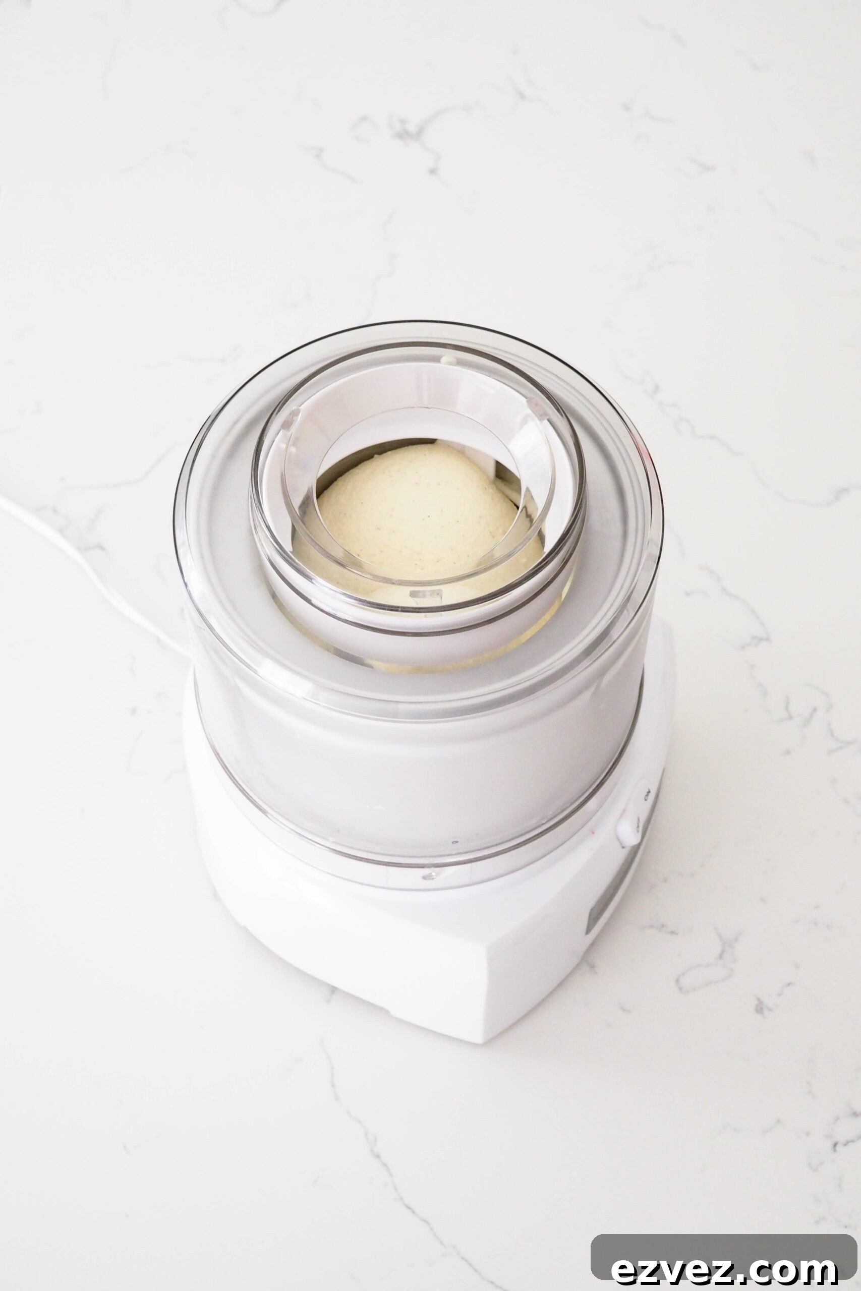 Ice cream in an ice cream maker with a lightly rounded dome.