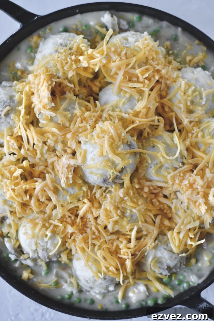 Topping the potatoes with cheddar cheese.