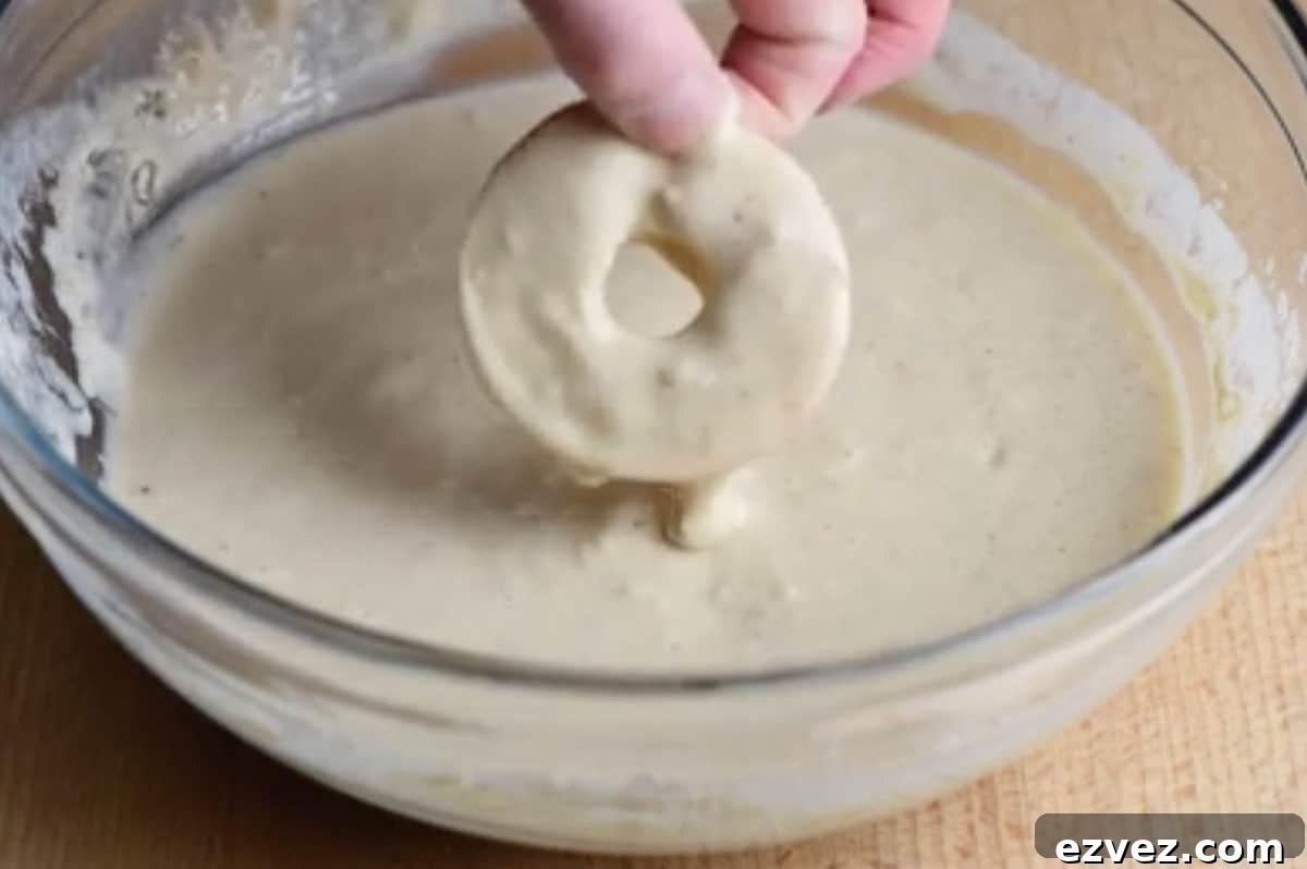 Sliced apple being dunked in batter