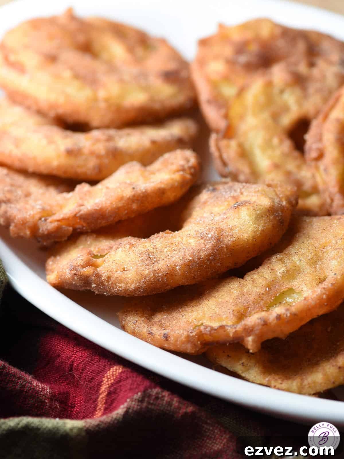 overlapping fried apple rings laying flat on a plate