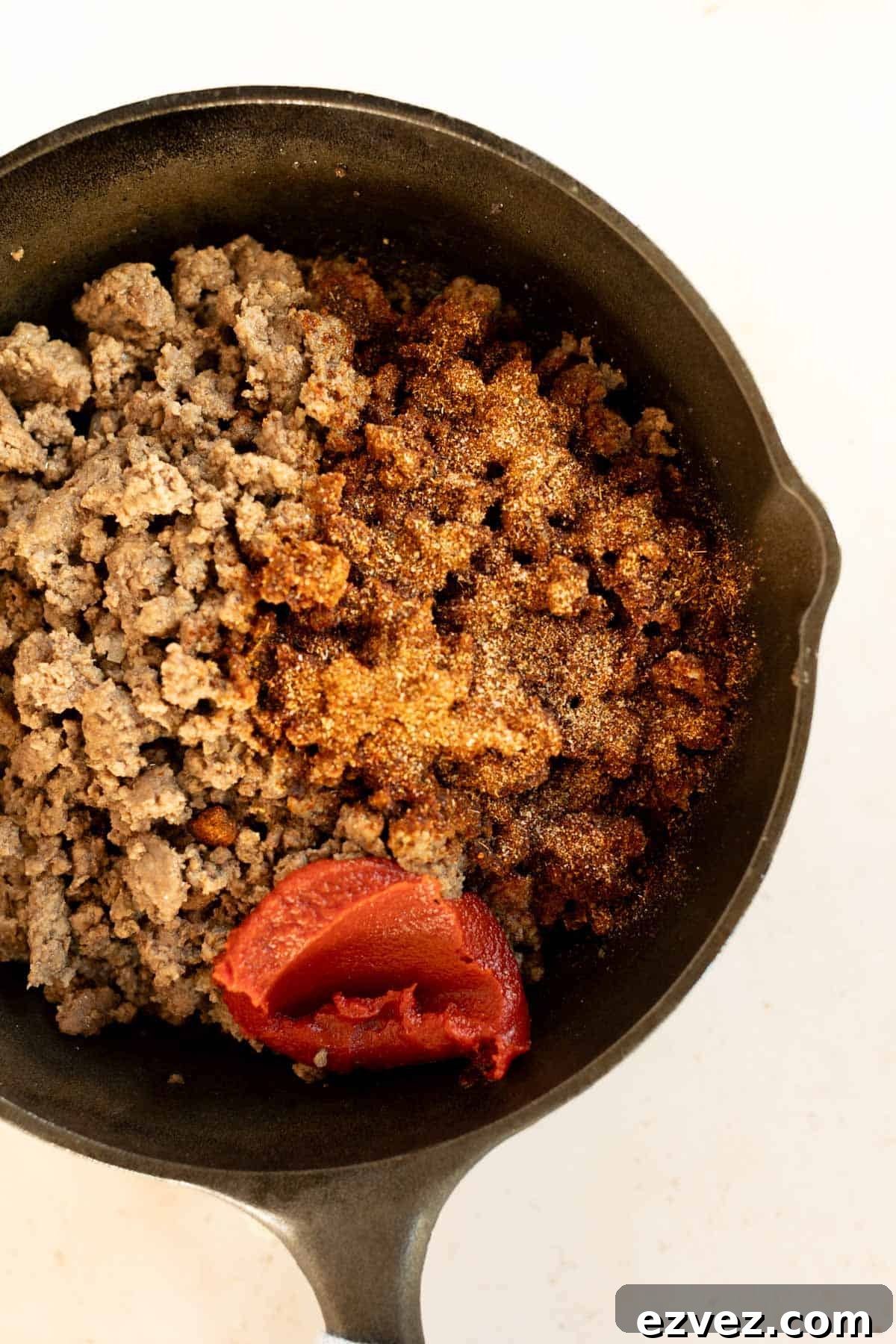A bowl of ground meat and tomato sauce.