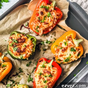 Turkey-Stuffed Bell Peppers with Savory Rice Filling 11 Cheesy stuffed peppers on a baking sheet.