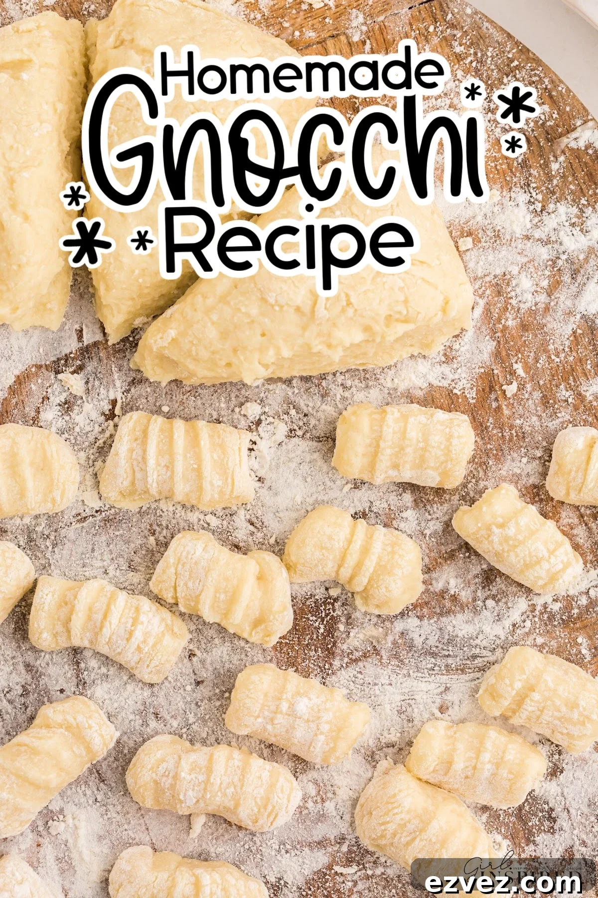 Homemade potato gnocchi on a wooden cutting board dusted with flour.