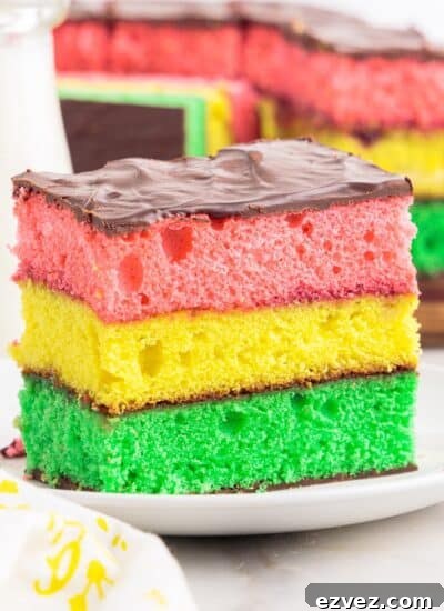 A plate with a slice of Italian Rainbow Cake on it.