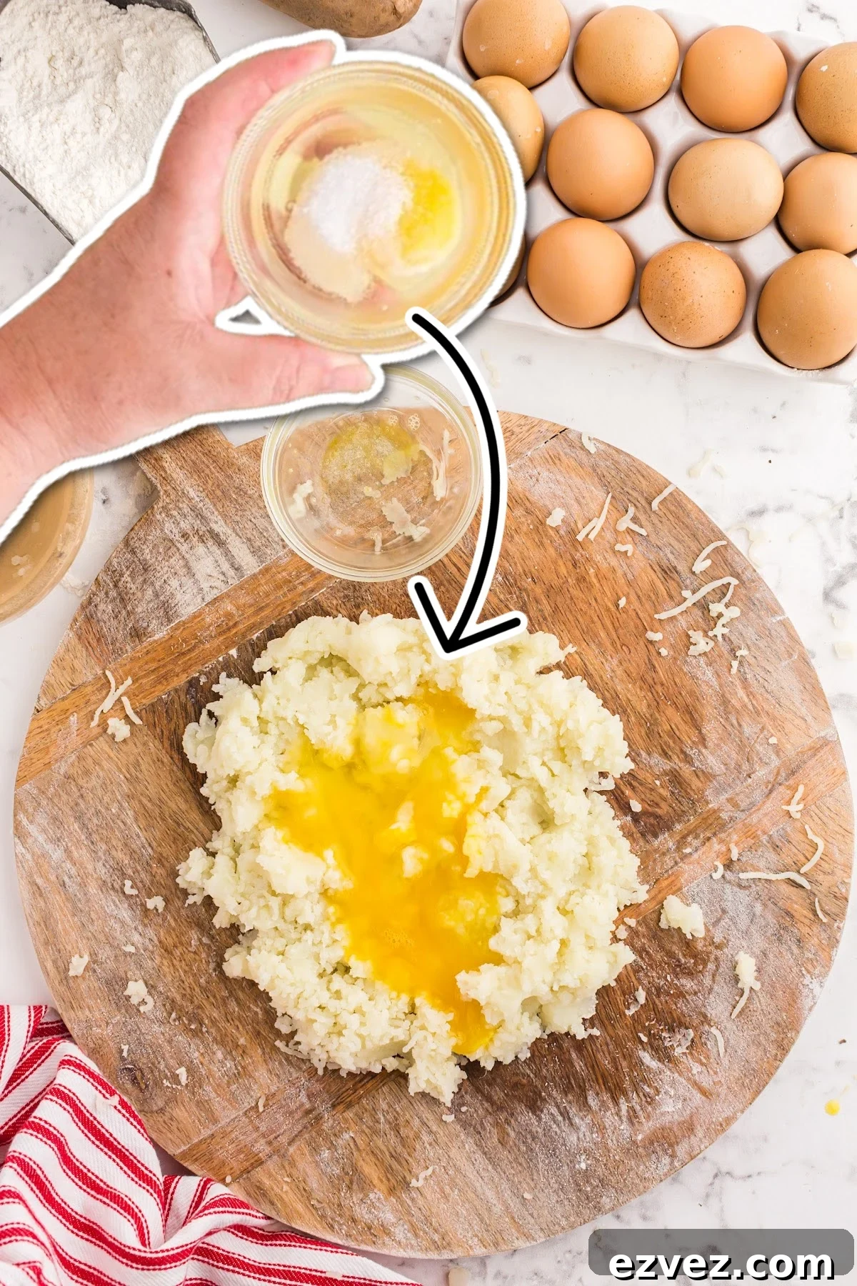 Adding eggs and ricotta to the mashed potatoes.