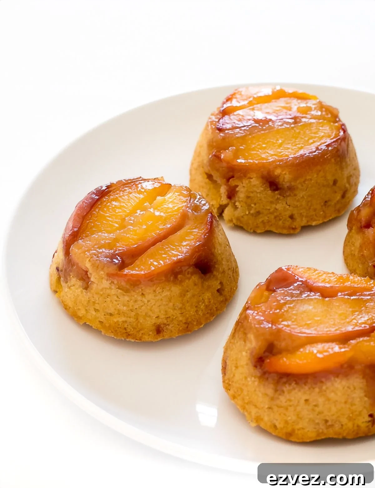Mini Peach Upside Down Cakes on a white plate.