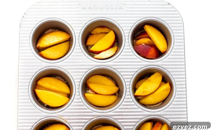 cubed butter, brown sugar and sliced peaches in a muffin tin