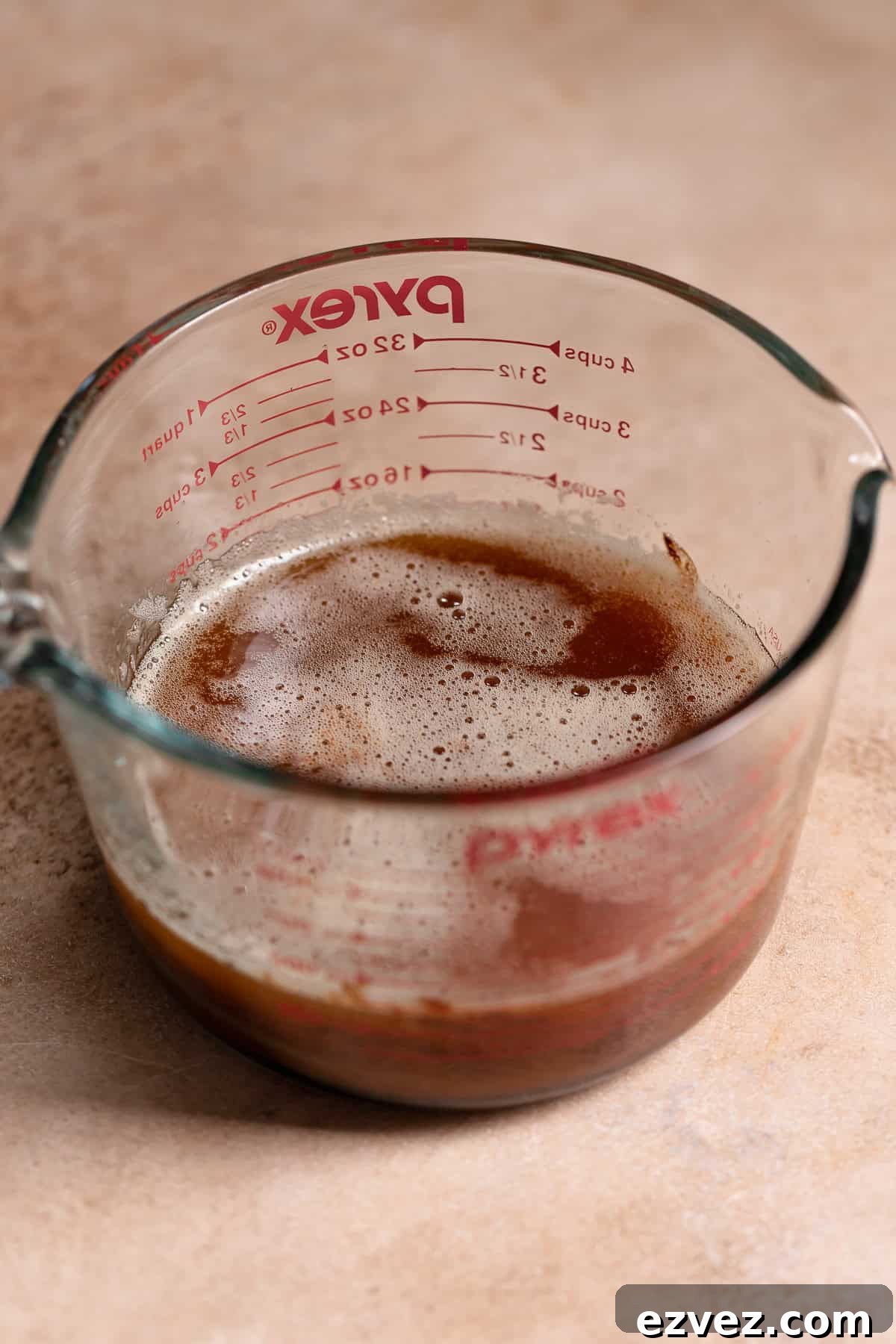 Fudgy Brown Butter Chocolate Brownie Cake Recipe 3 Melted brown butter and chocolate in a glass measuring cup.