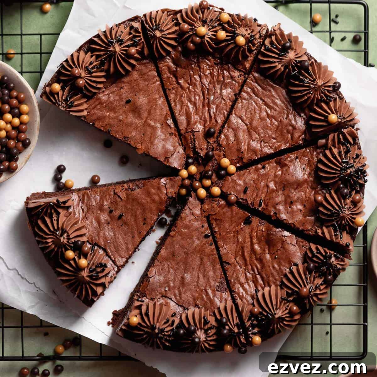 Fudgy Brown Butter Chocolate Brownie Cake Recipe 10 Brown butter brownie cake cut into slices on parchment paper.