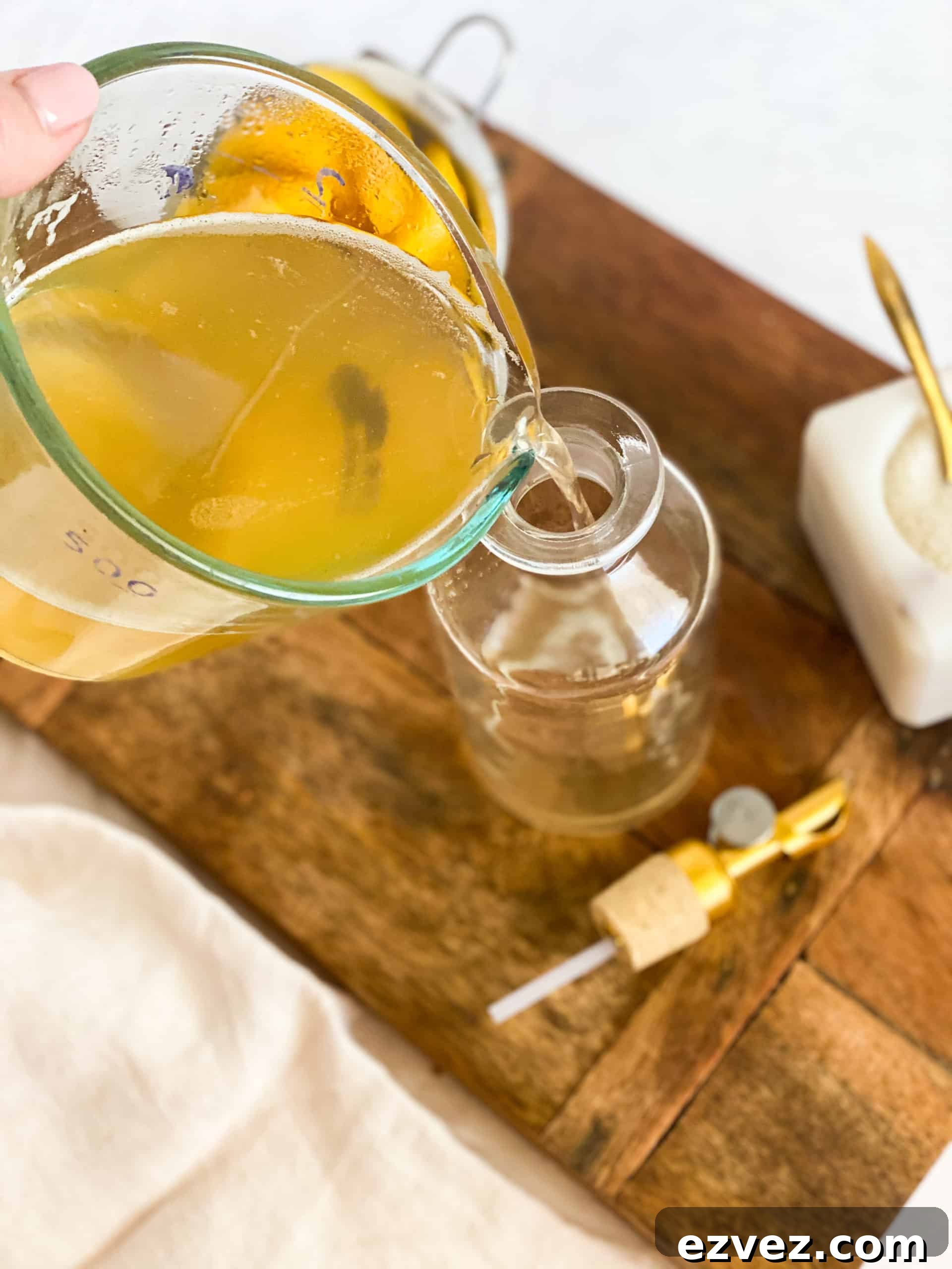 Peach Simple Syrup being poured into a glass