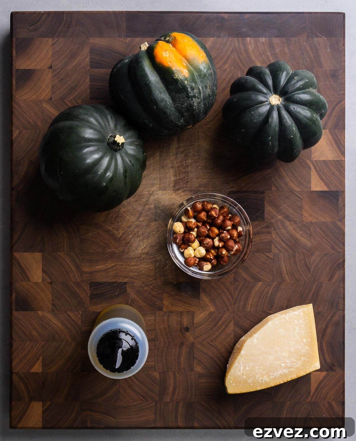 Ingredients shown: acorn squash, hazelnuts, olive oil, and Parmigiano Reggiano cheese.