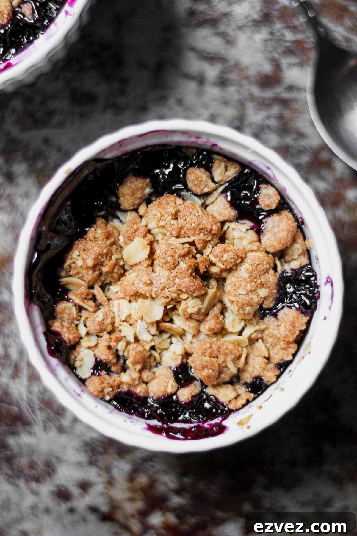 vegan blueberry crisp recipe in a small white ramekin for baking blog