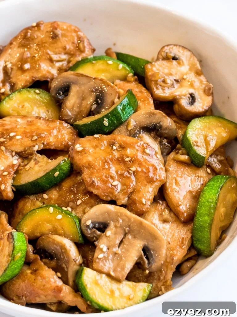 Panda Express Mushroom Chicken stir fry with zucchini in a white bowl