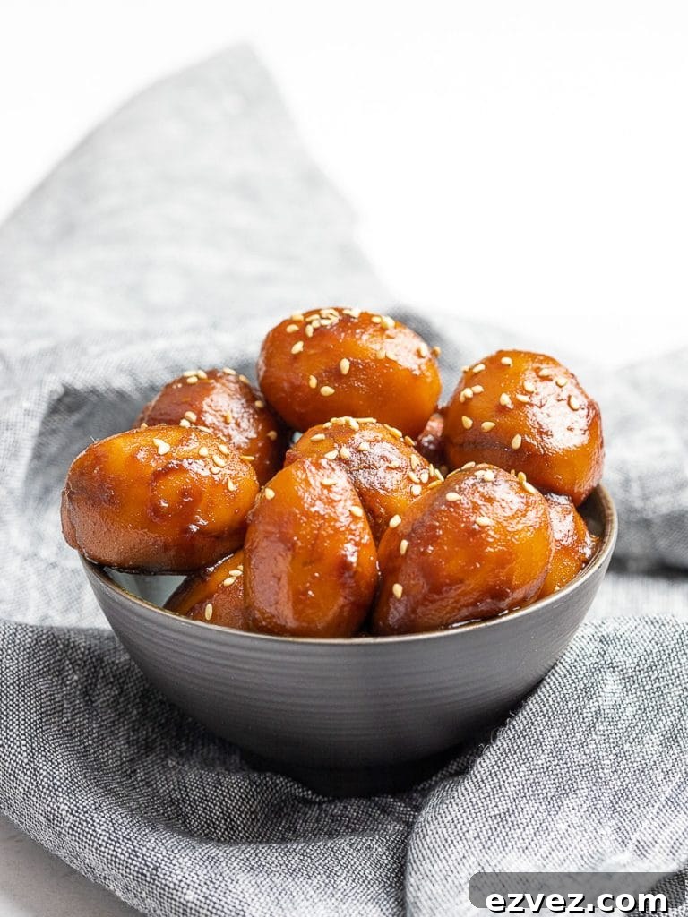Korean Potato Side Dish, Gamja Jorim in a grey bowl on top of linen