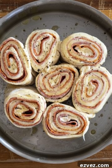 Pepperoni Stromboli: Cheesy Pepperoni Bread Recipe 6 dough cut into equal length rolls and placed on their sides in a cake pan. Leaving about an inch or two on the sides.