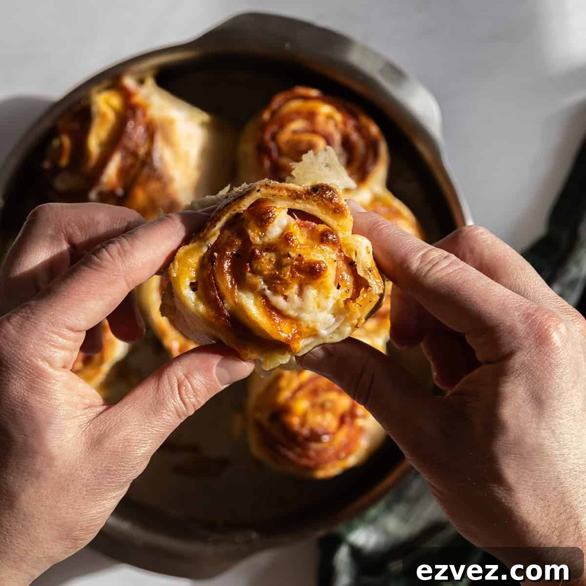 Pepperoni Stromboli: Cheesy Pepperoni Bread Recipe 8 holding a pepperoni stromboli
