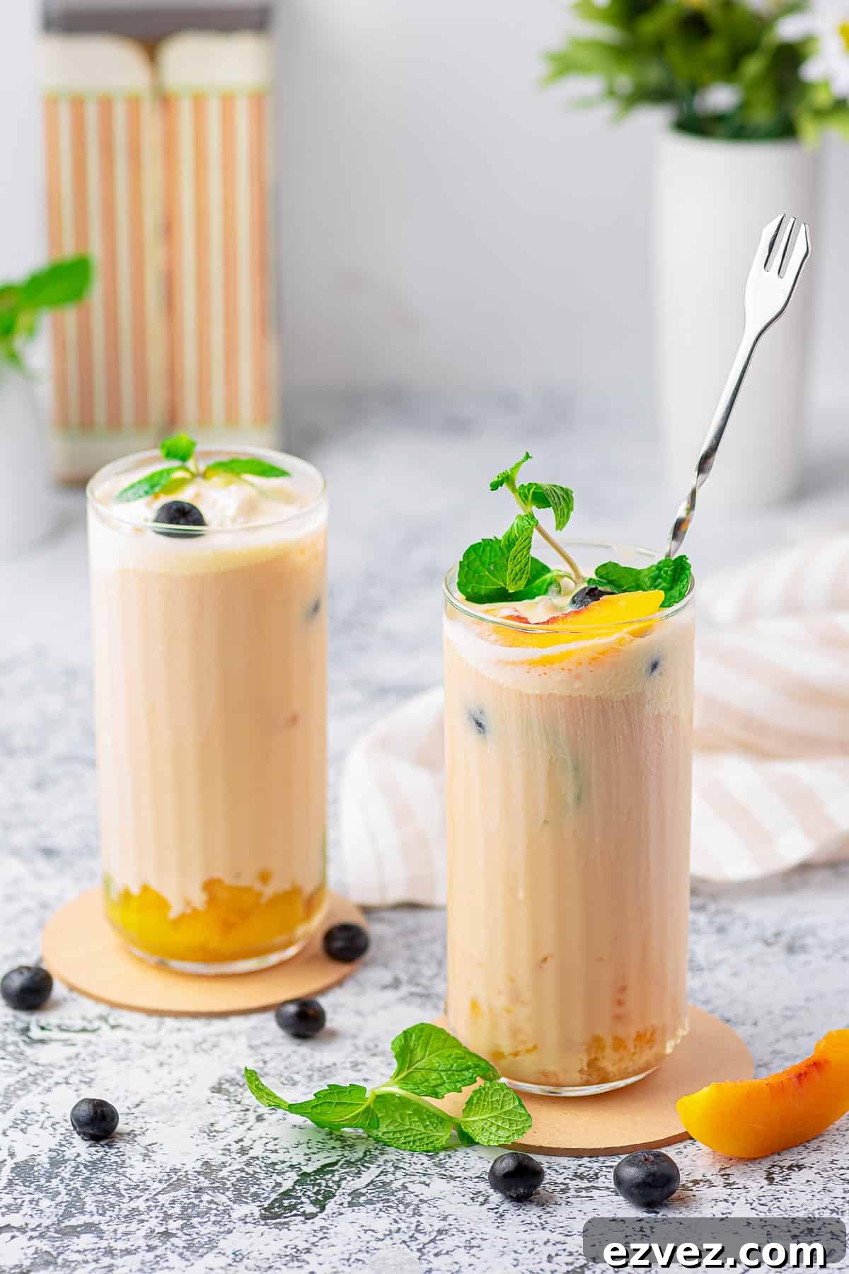 Creamy Peach Iced Tea Recipe: Smooth, Refreshing Summer Drink 6 Two glasses of Creamy Peach Tea on coasters.