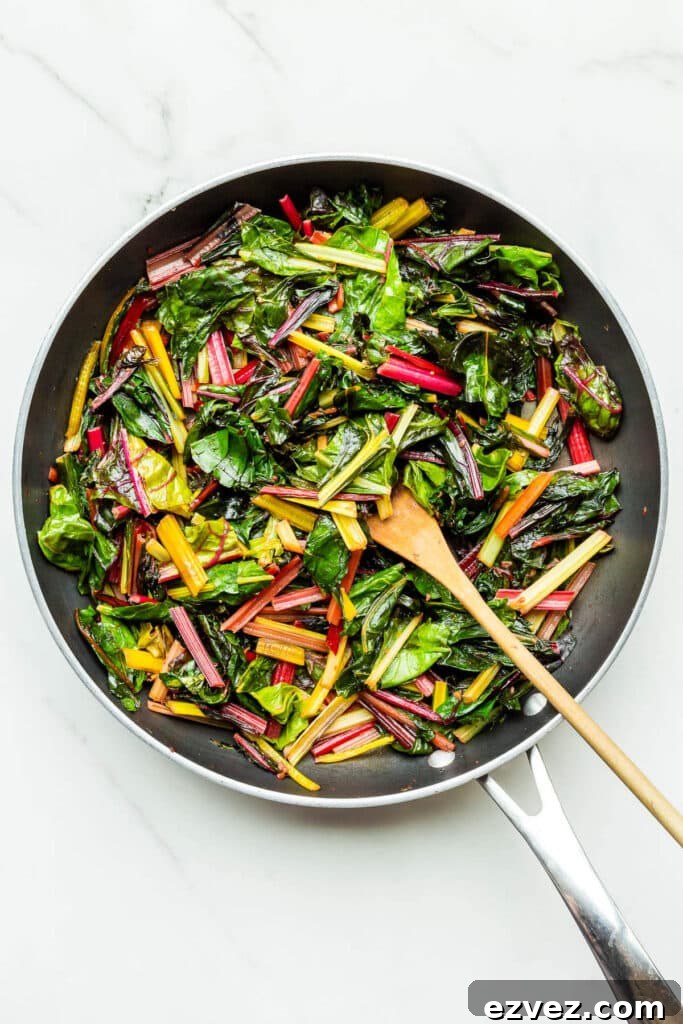 Sautéeing rainbow Swiss chard in a fry pan to make quiche filling.