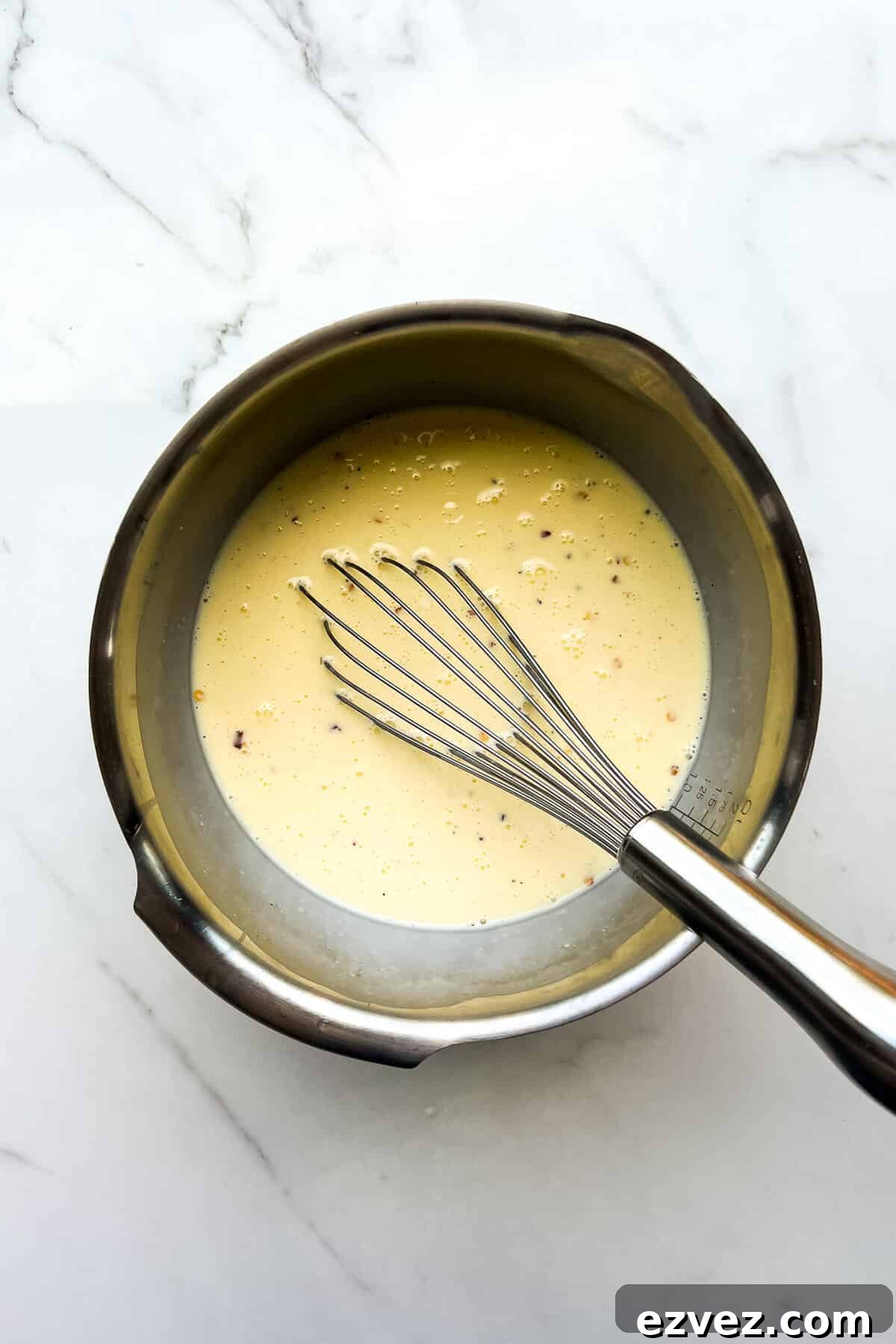 A whisked quiche filling of eggs, milk, cream, and spices.
