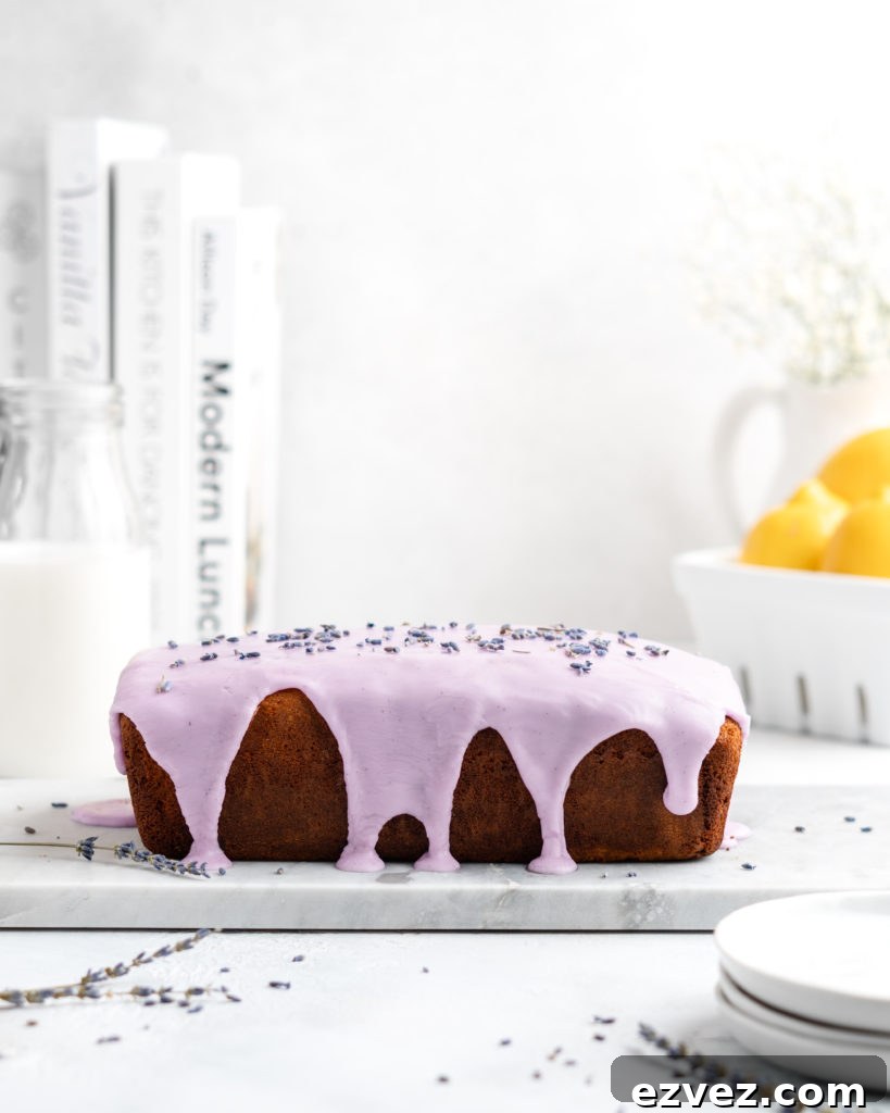 Fluffy and moist Lemon and lavender loaf cake is glazed in a purple coloured vanilla glaze